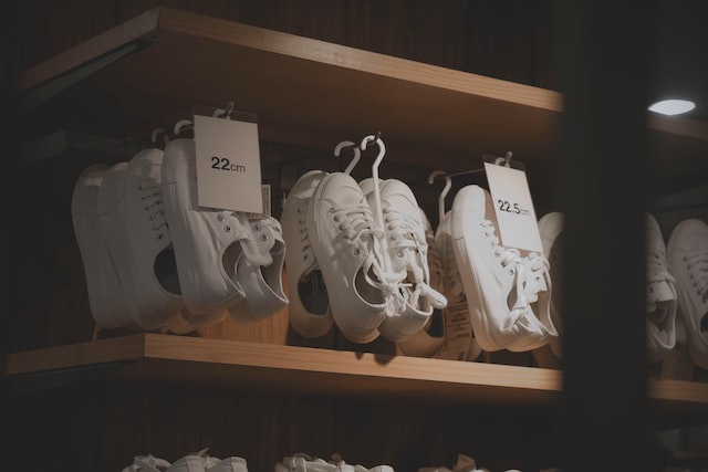 pile of white sneakers with price tags