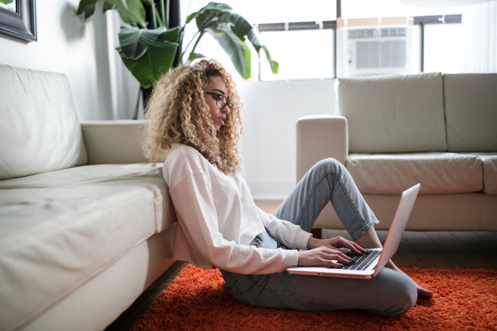 woman sitting on floor with notebook